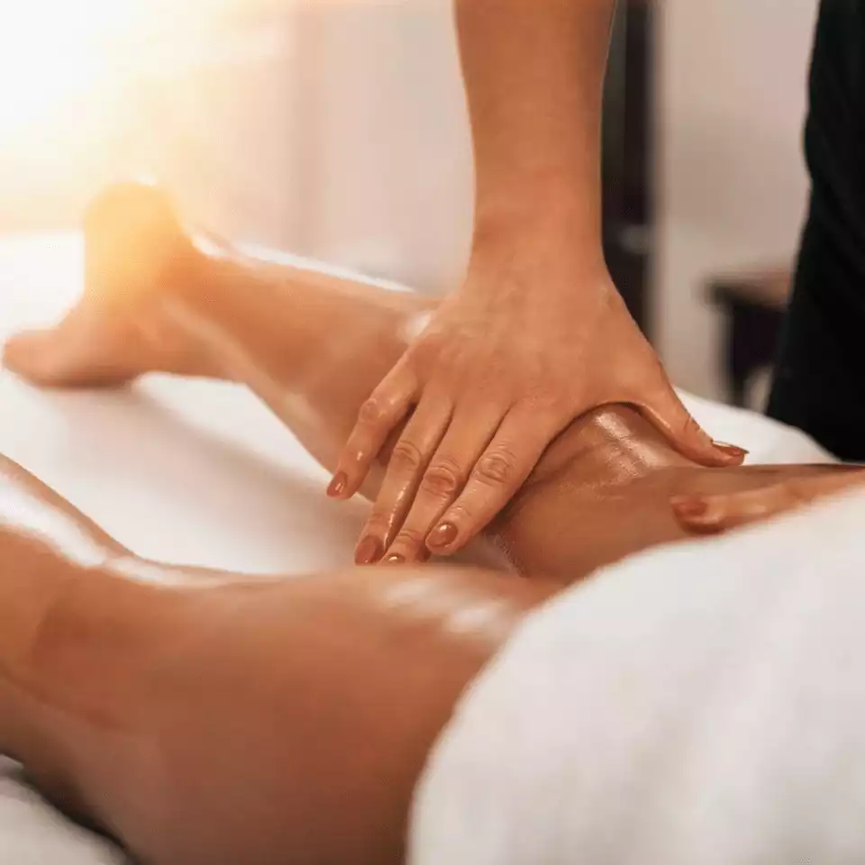 Sur cette image on voit une personne pratiquer un massage dont le nom est drainage lymphatique sur une personne.